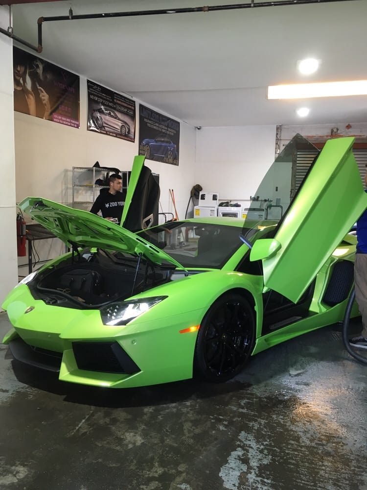 Green Lamborghini with doors raised at W12 Car Spa