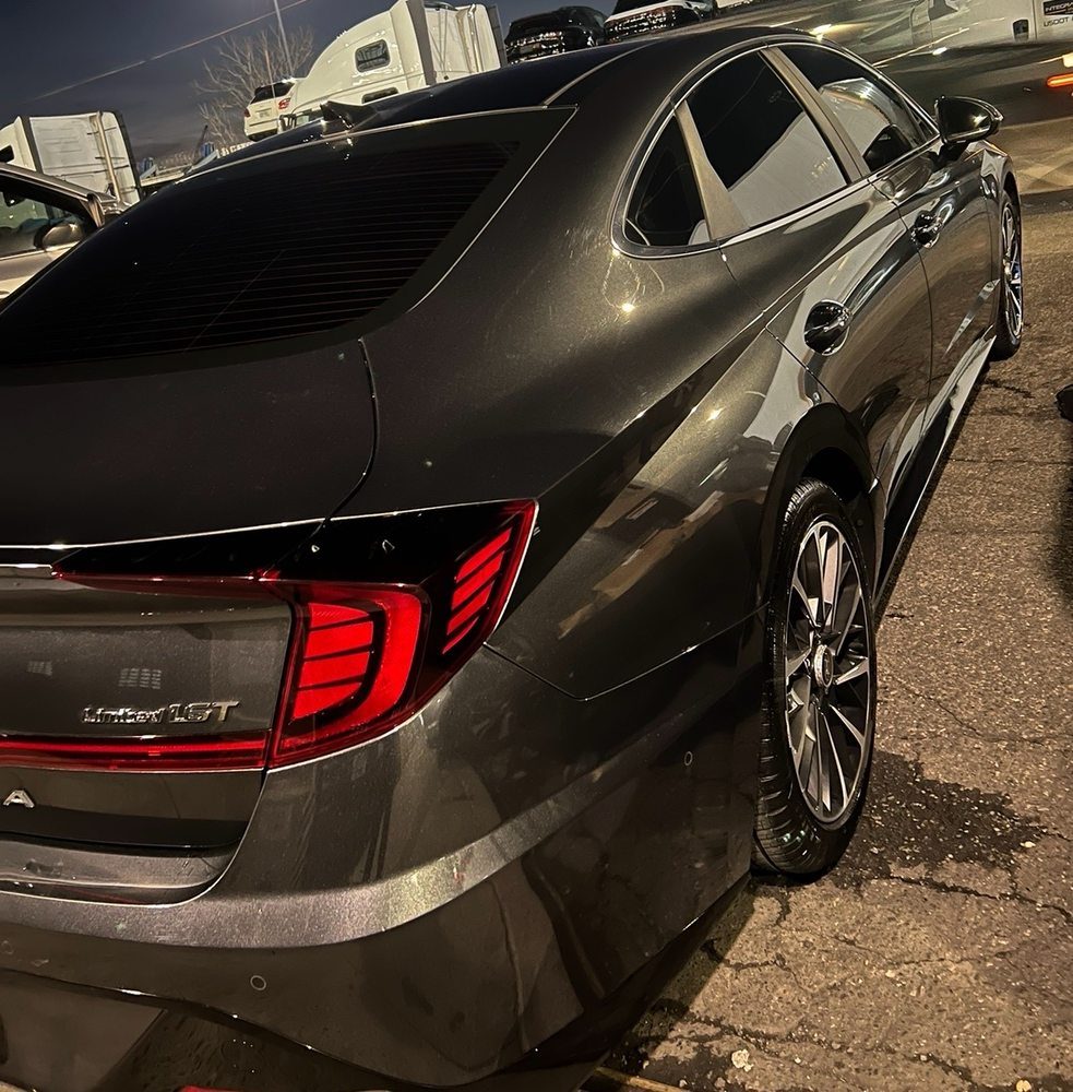 A dark car gleaming after a full hand detail