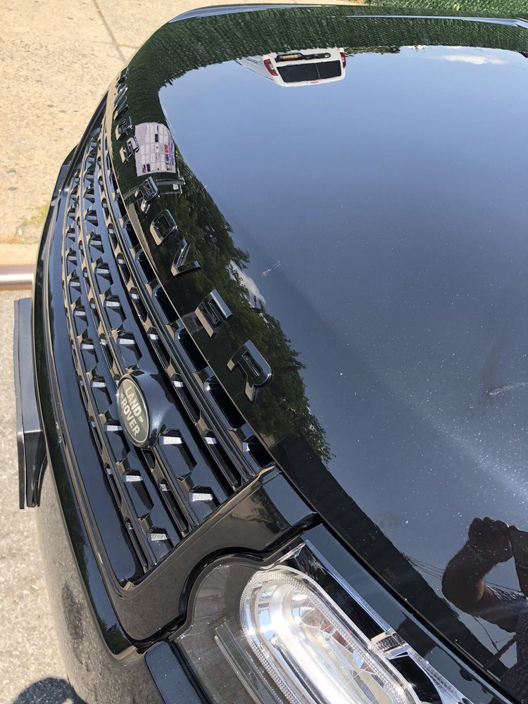 Glossy black Range Rover hood after a hand wash